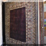 R77. Wide bordered handknotted wool rug. Approx. 8' x 10' 